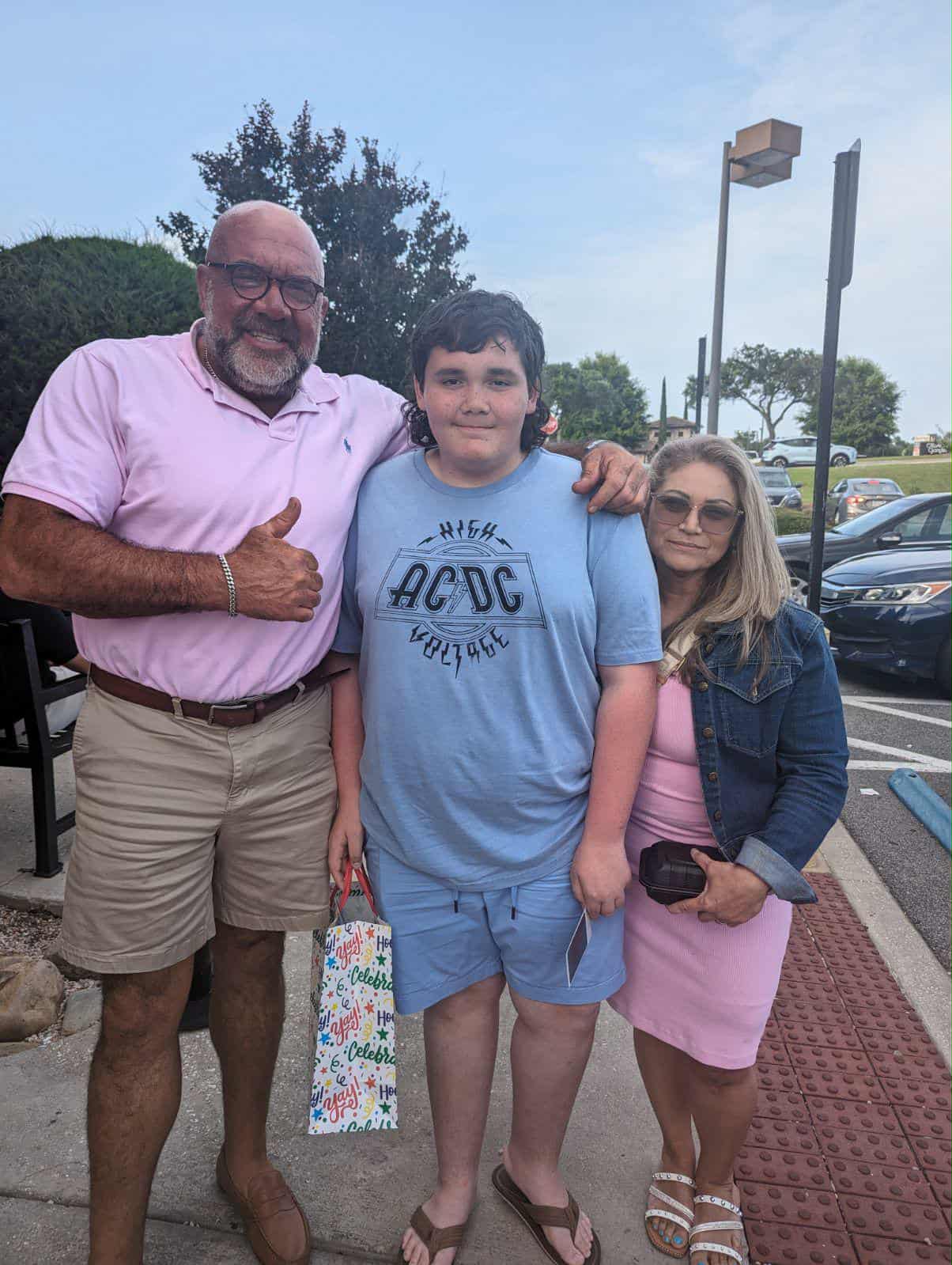 Hammer and his wife with a young friend outdoors