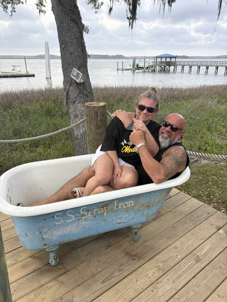 Hammer and his wife relaxing together in a vintage bathtub by the lake