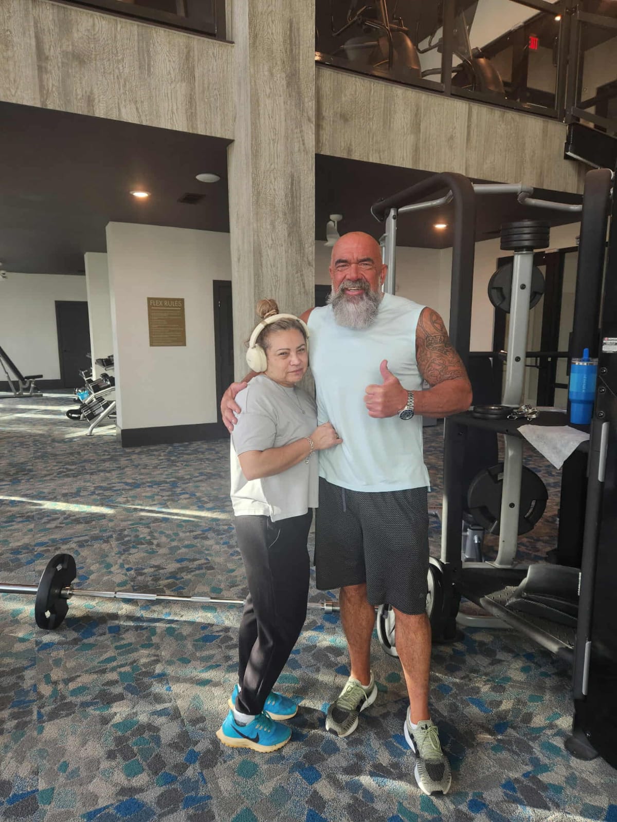 Hammer and his wife together at the gym, both in workout attire