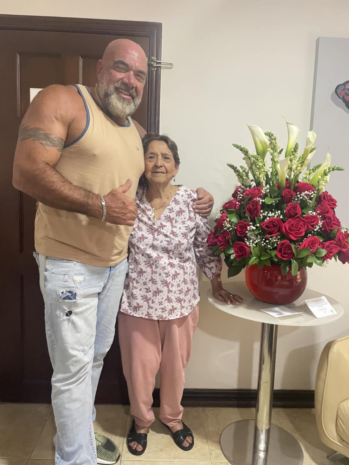 Hammer with an elderly woman in a home setting with beautiful flowers